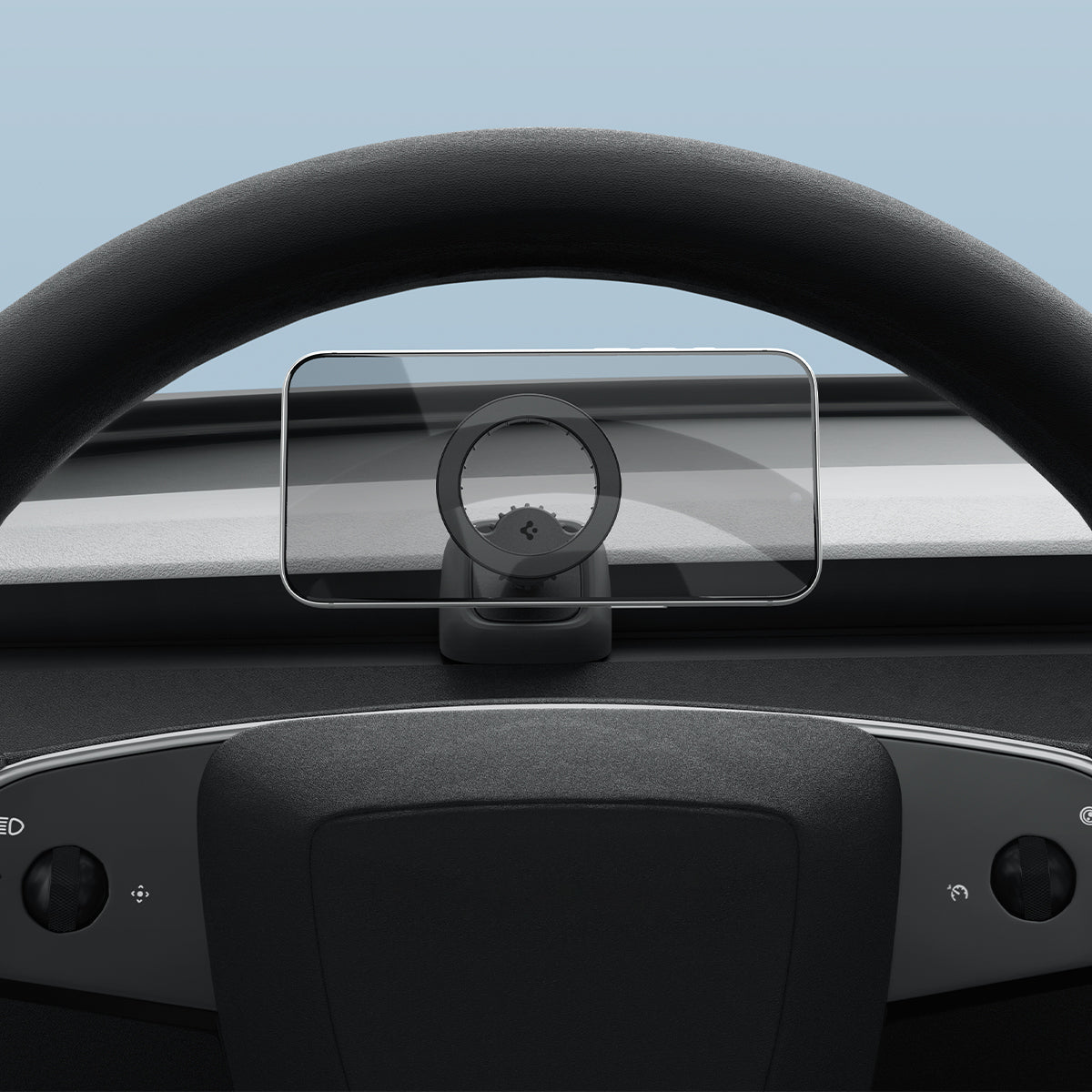 Spigen TAM100 behind the steering wheel of the Tesla