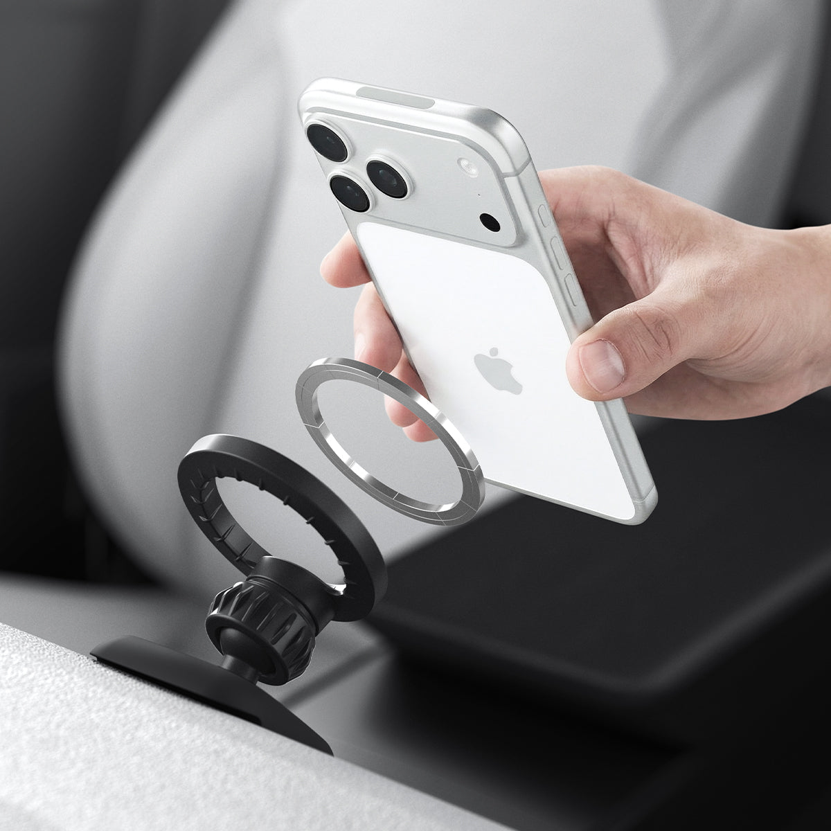 iPhone being attached to the Spigen MagSafe mount TAM100